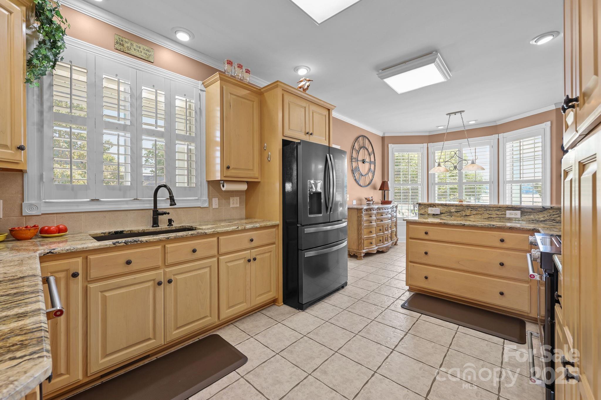 17200 Randalls Ferry Road Norwood, NC 28128 - Photo 16 of 48 a kitchen with a refrigerator and a sink