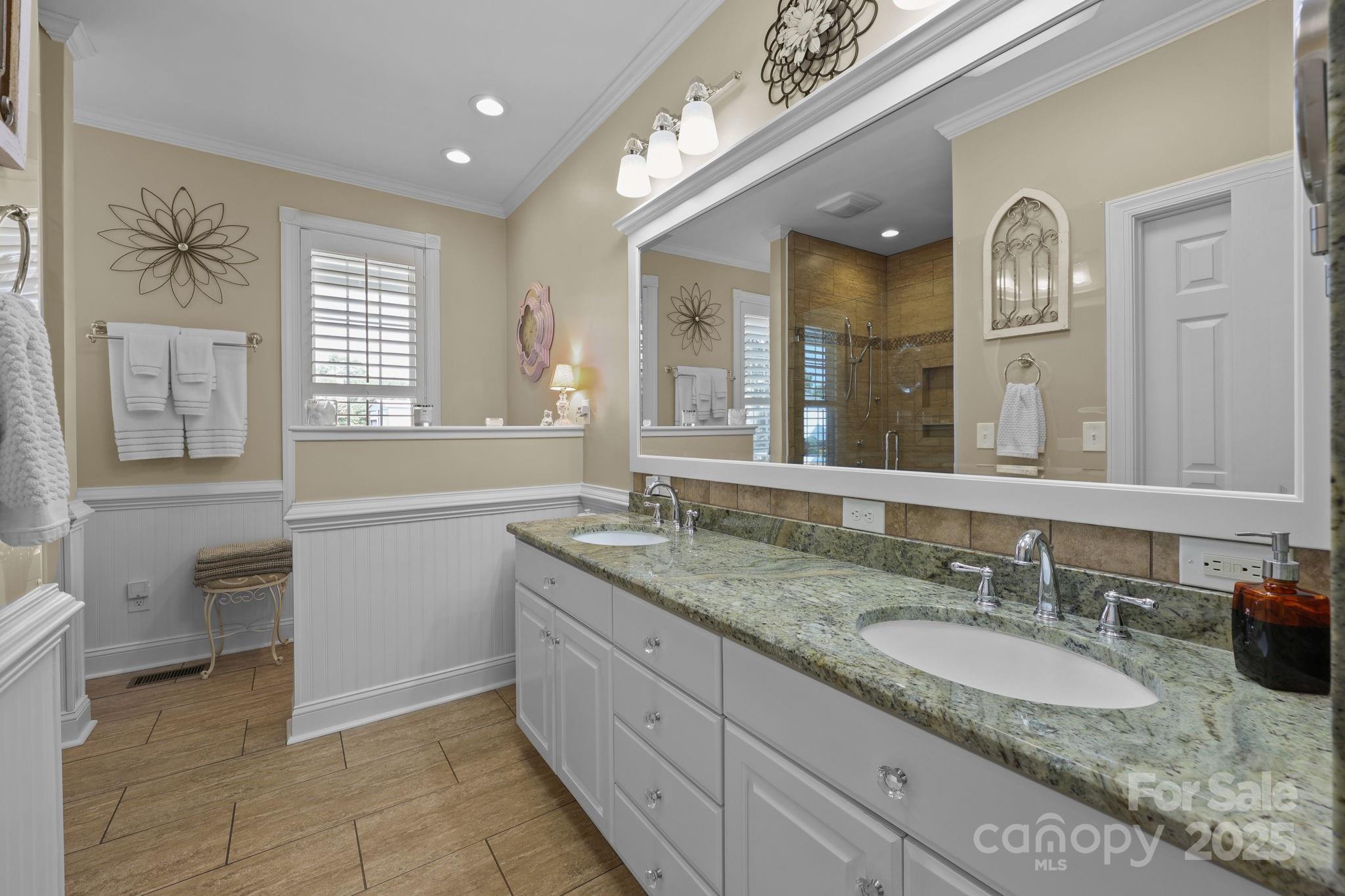 17200 Randalls Ferry Road Norwood, NC 28128 - Photo 22 of 48 a bathroom with a granite countertop sink a large mirror and a bathtub