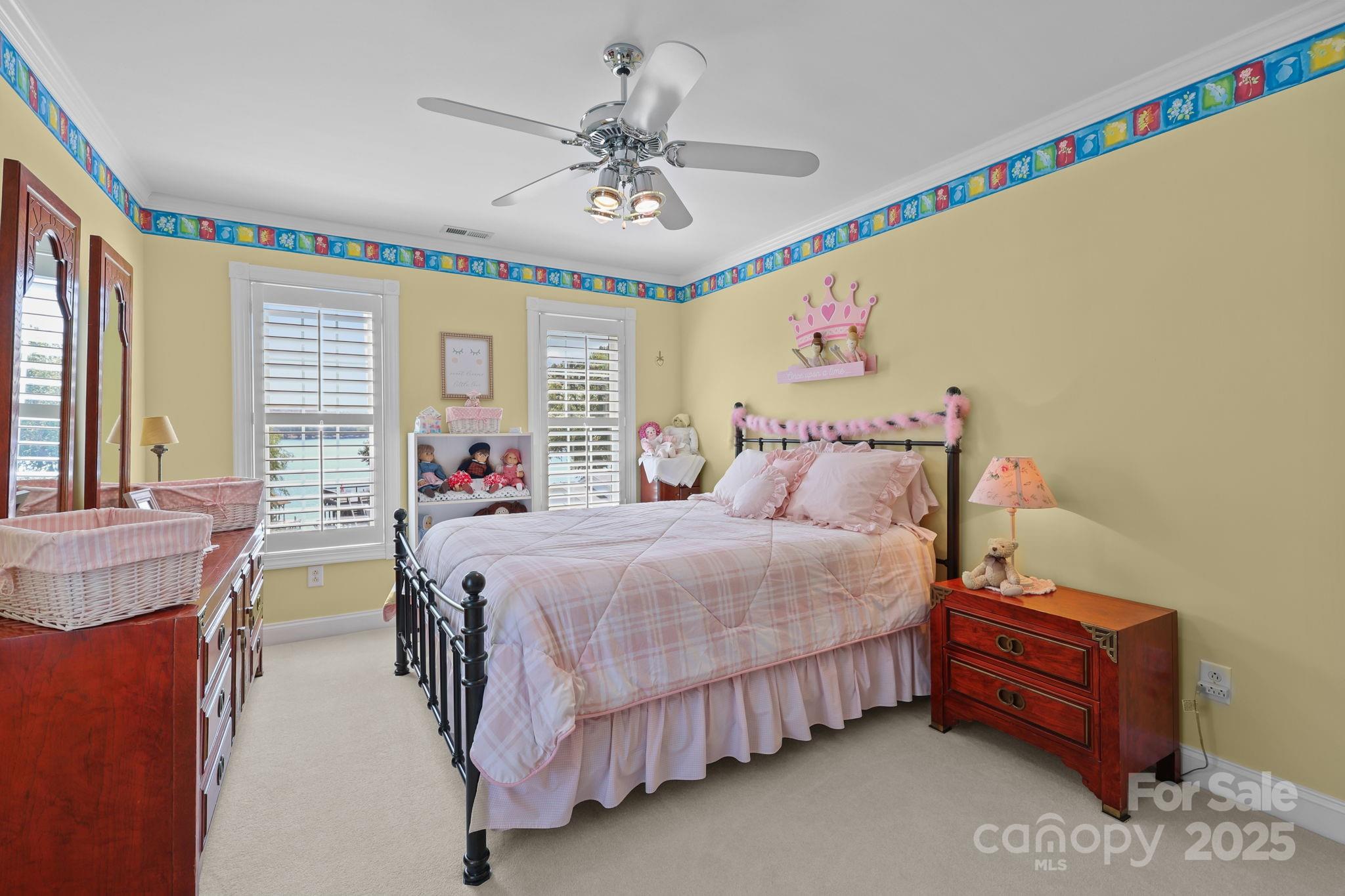 17200 Randalls Ferry Road Norwood, NC 28128 - Photo 30 of 48 a spacious bedroom with a bed and a chandelier