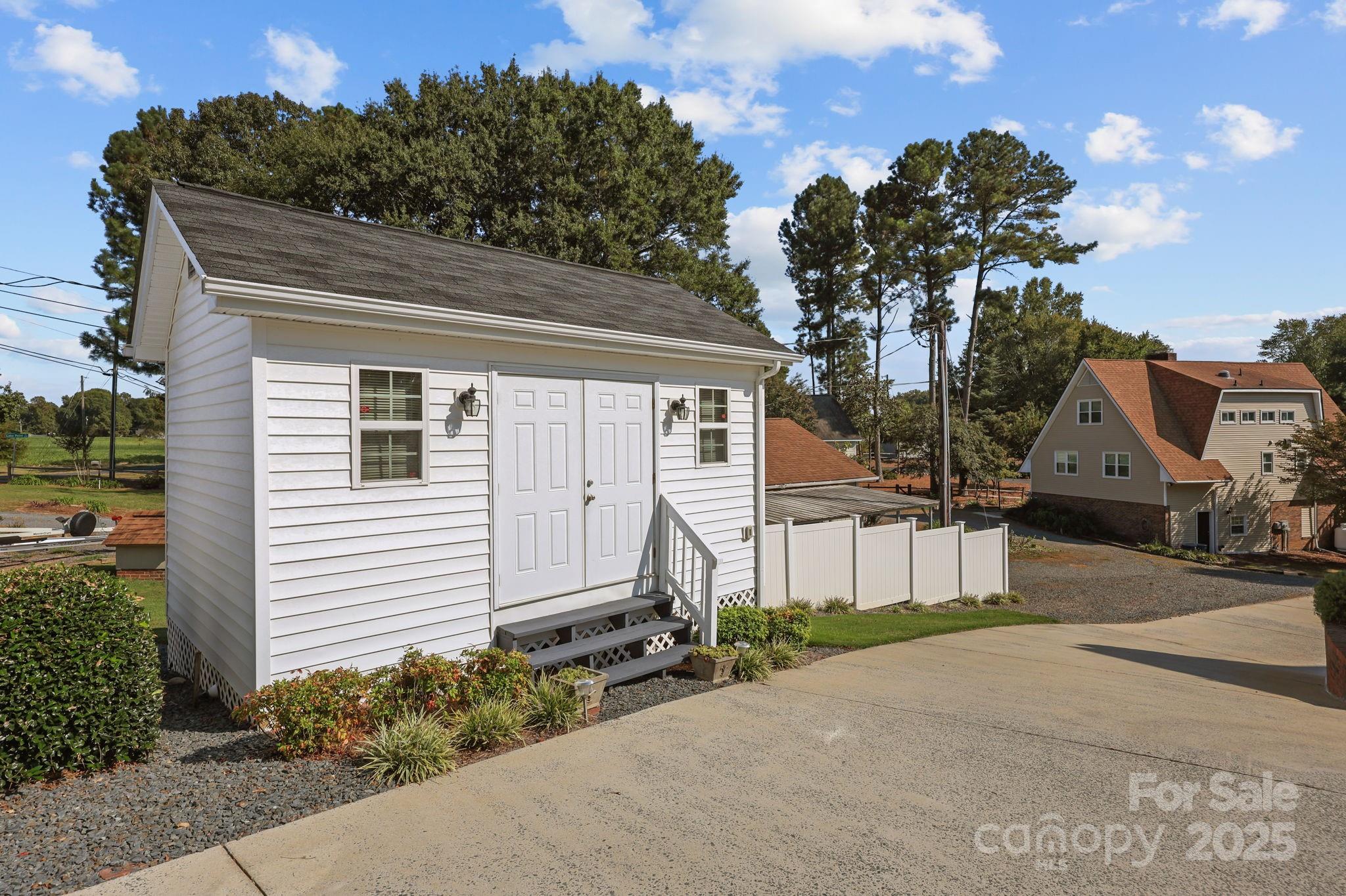 17200 Randalls Ferry Road Norwood, NC 28128 - Photo 47 of 48 a front view of a house with a yard and garage