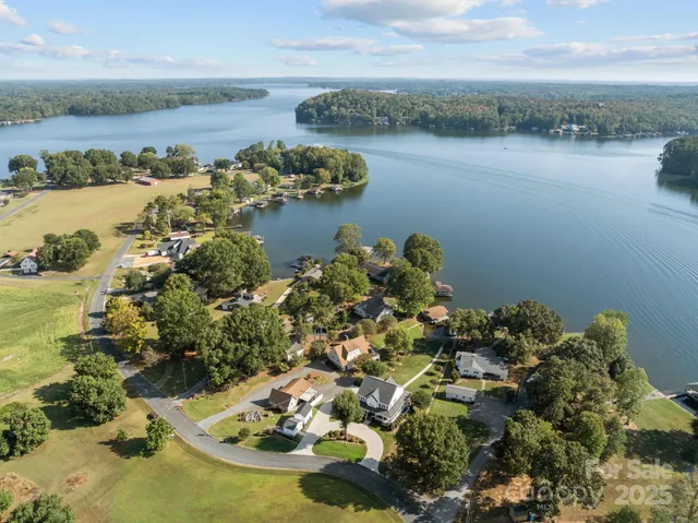 a view of a lake with lawn chairs