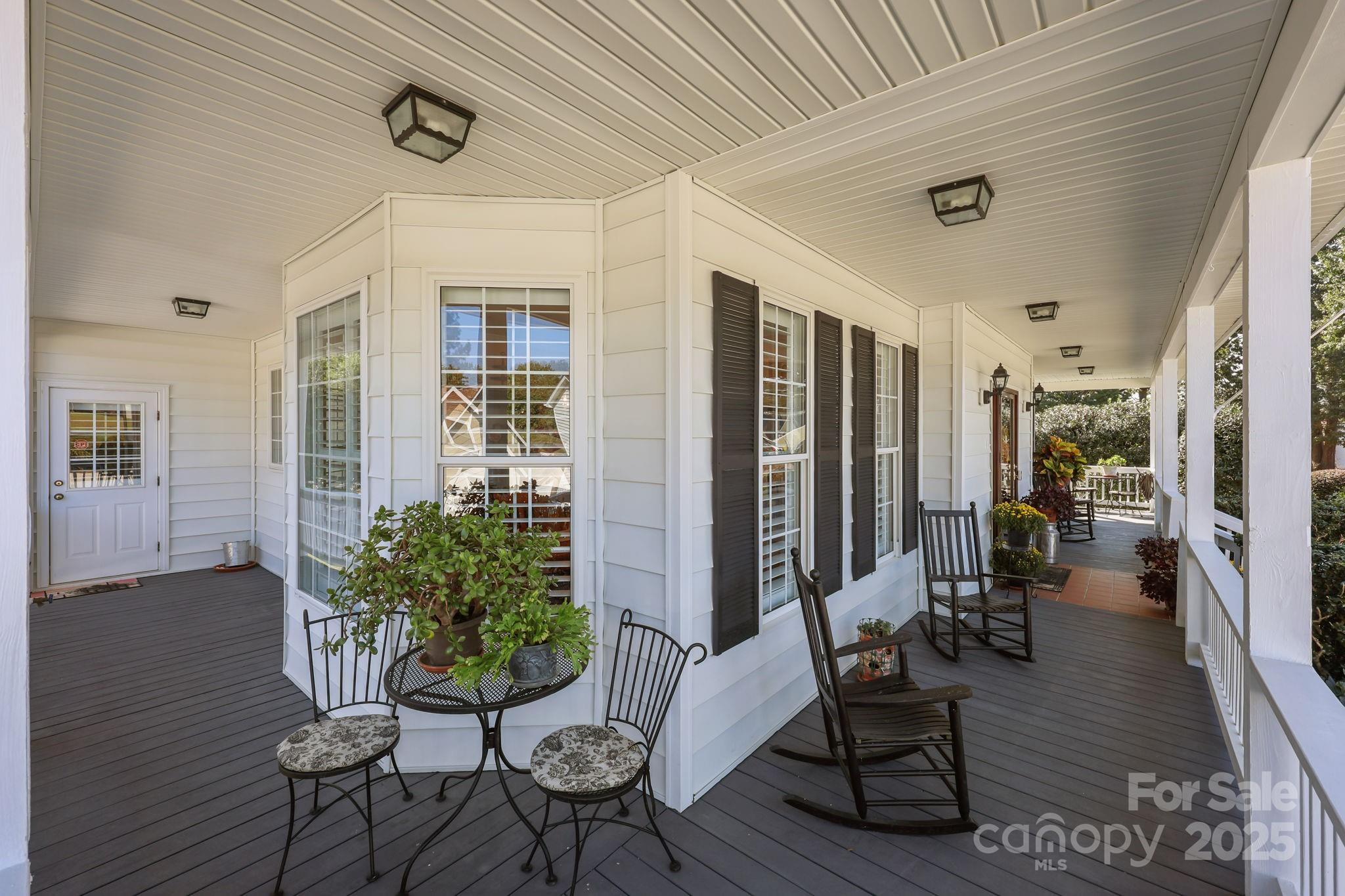17200 Randalls Ferry Road Norwood, NC 28128 - Photo 9 of 48 a view of a patio with table and chairs potted plants with wooden floor