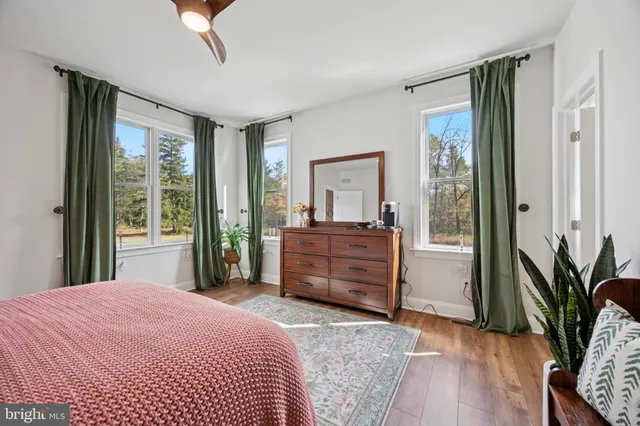 a living room with furniture a window and gym equipment