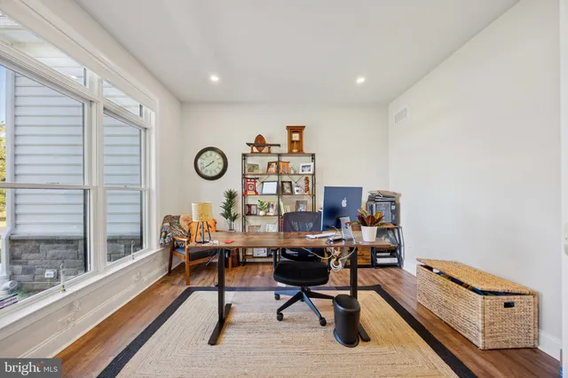 a bathroom with a toilet a sink a mirror a vanity and shower