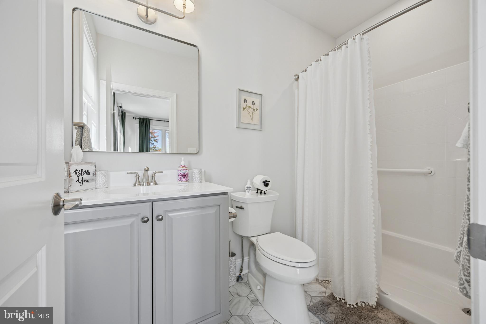 232 South Sugan Road New Hope, PA 18938 - Photo 21 of 31 a bathroom with a toilet a sink a mirror a vanity and shower