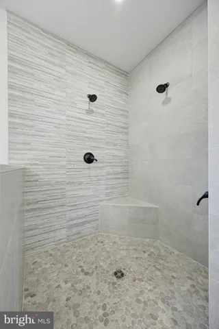 a bathroom with a tub sink and a mirror