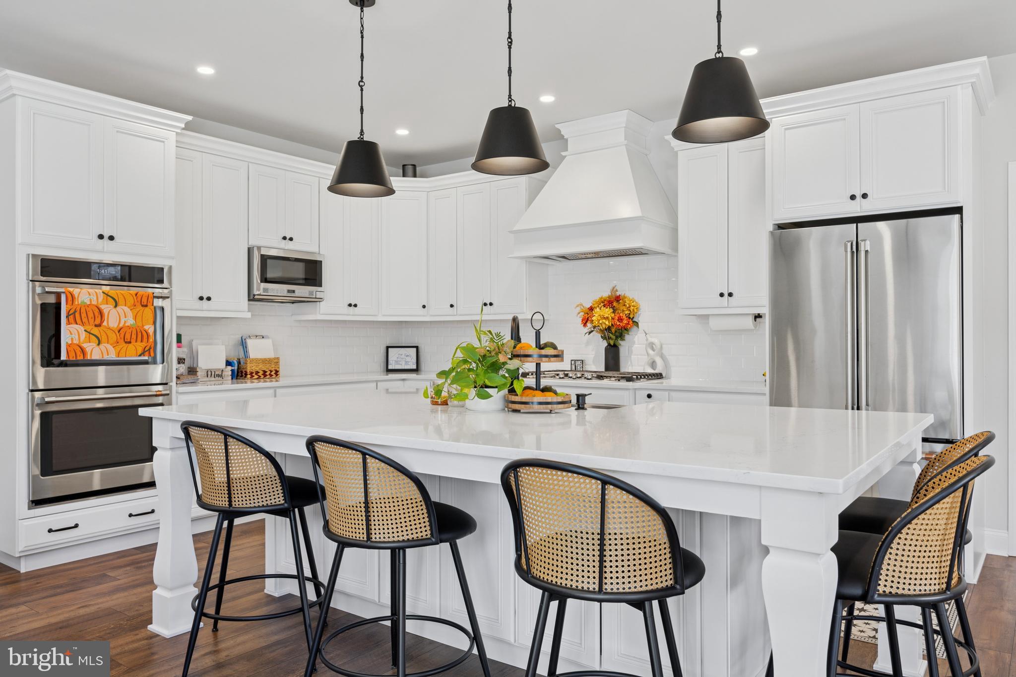232 South Sugan Road New Hope, PA 18938 - Photo 5 of 31 a kitchen with stainless steel appliances granite countertop a sink a microwave a refrigerator and chairs