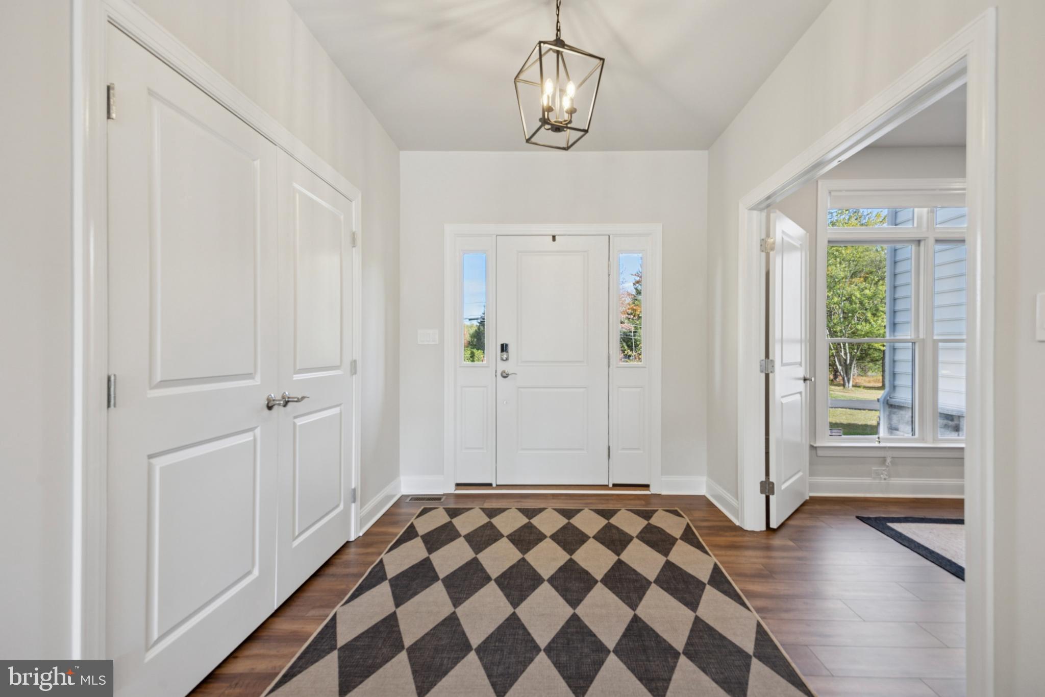 232 South Sugan Road New Hope, PA 18938 - Photo 9 of 31 a spacious bedroom with a bed and a chandelier