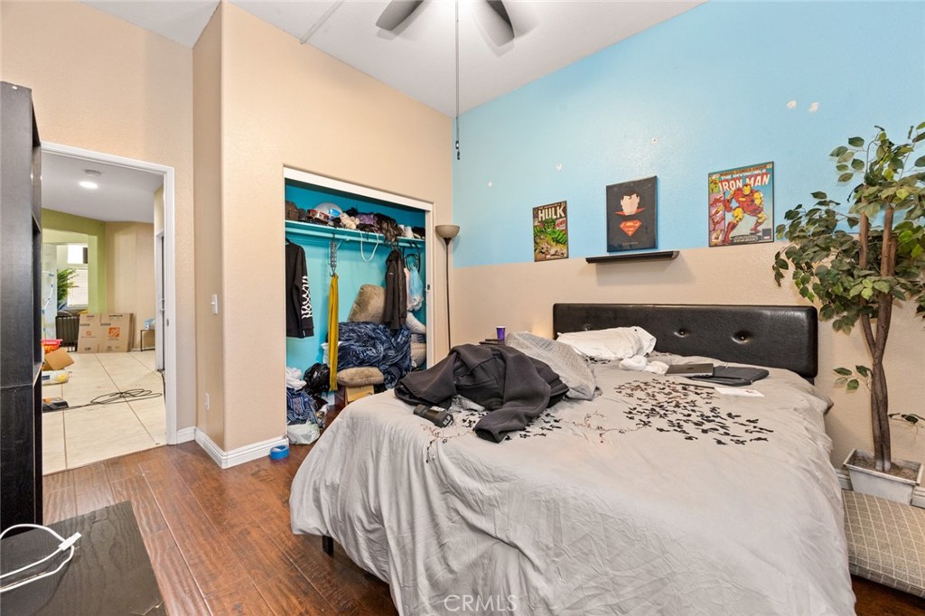 410 Windfields Way Beaumont, CA 92223 - Photo 11 of 41 a bedroom with a bed and a chandelier