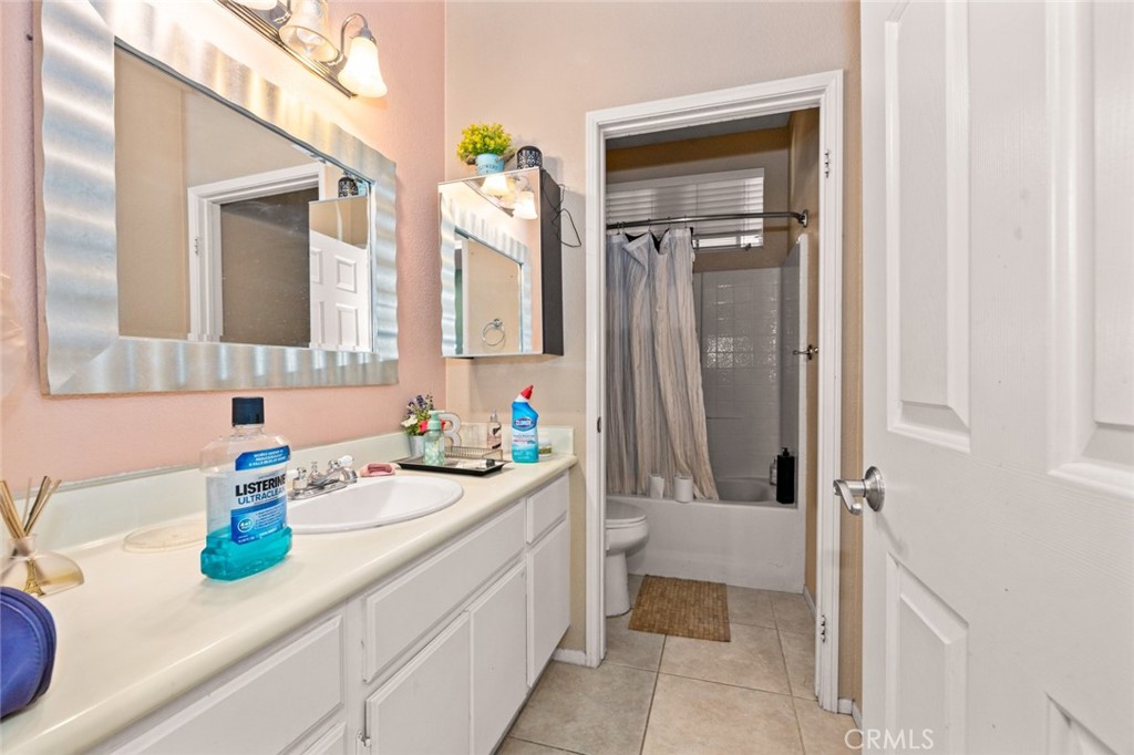 410 Windfields Way Beaumont, CA 92223 - Photo 12 of 41 a bathroom with a sink a toilet and shower