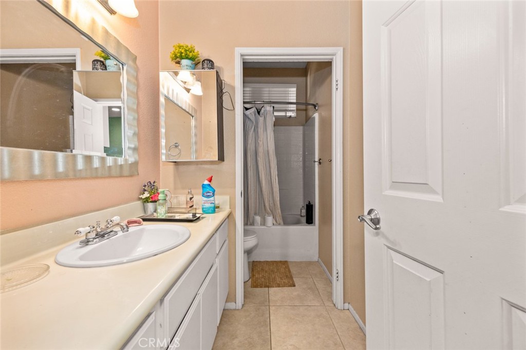 410 Windfields Way Beaumont, CA 92223 - Photo 13 of 41 a bathroom with a sink a vanity and a mirror