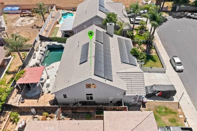 an aerial view of a house with a yard