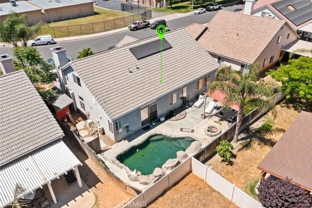 an aerial view of a house with a yard