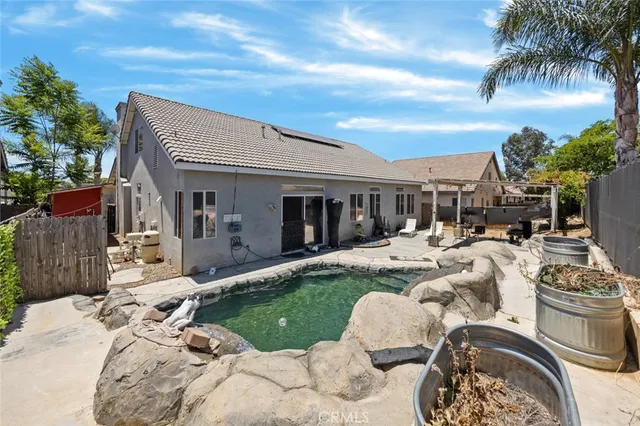 a view of a house with backyard and sitting area