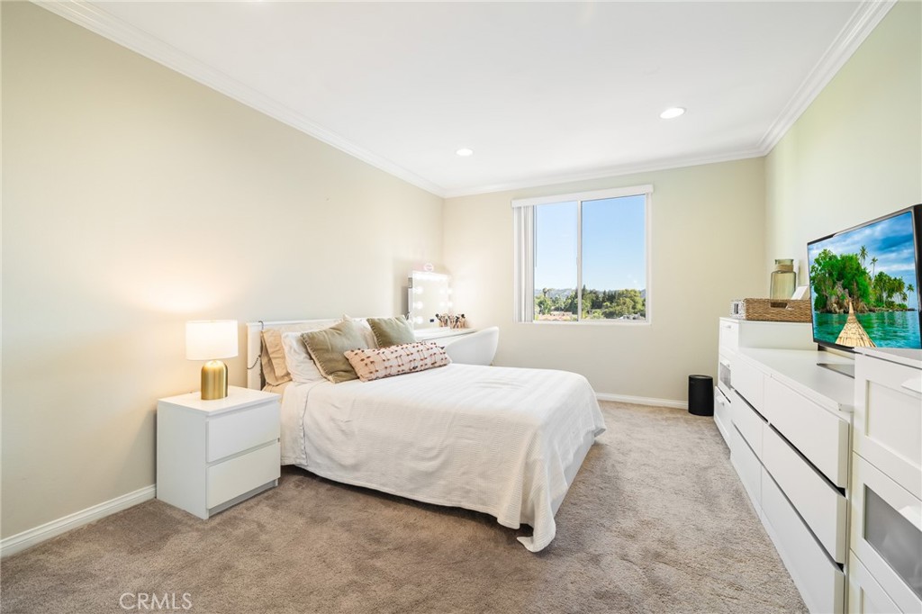 12830 Burbank Boulevard, Unit 307 Valley Village, CA 91607 - Photo 13 of 25 a bedroom with a bed and a flat screen tv