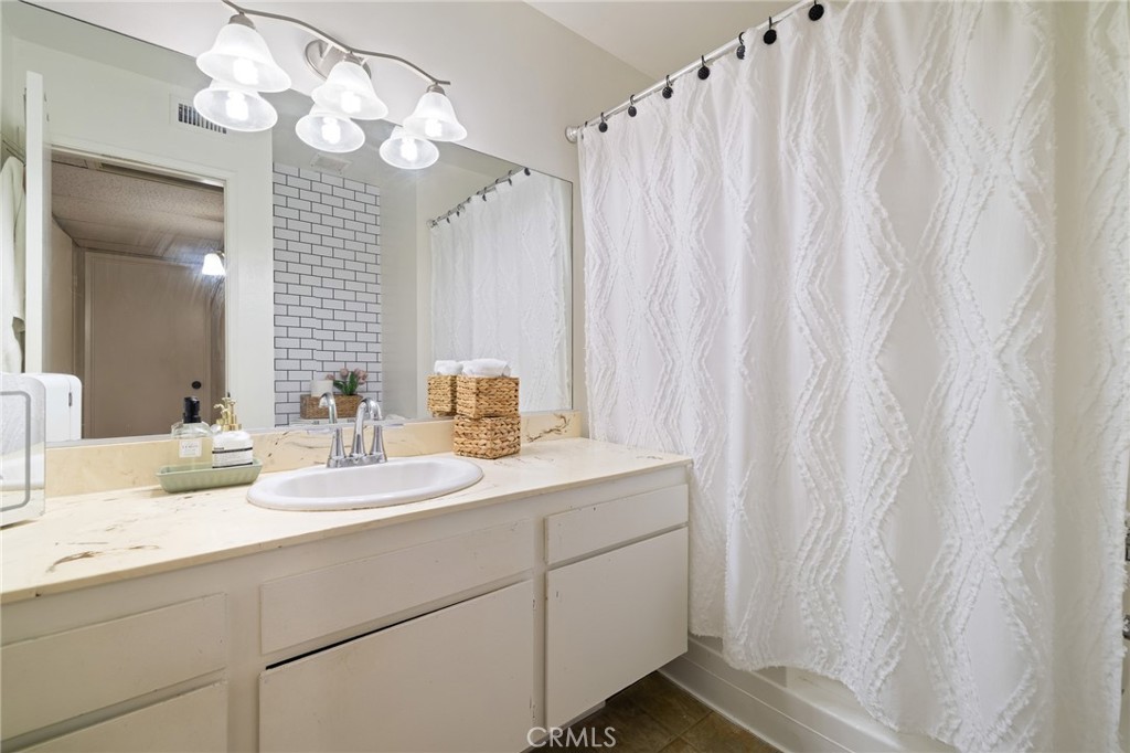 12830 Burbank Boulevard, Unit 307 Valley Village, CA 91607 - Photo 15 of 25 a bathroom with a sink vanity granite and a mirror