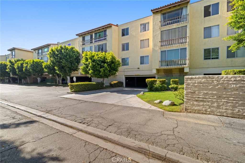 12830 Burbank Boulevard, Unit 307 Valley Village, CA 91607 - Photo 21 of 25 a view of a building with a yard