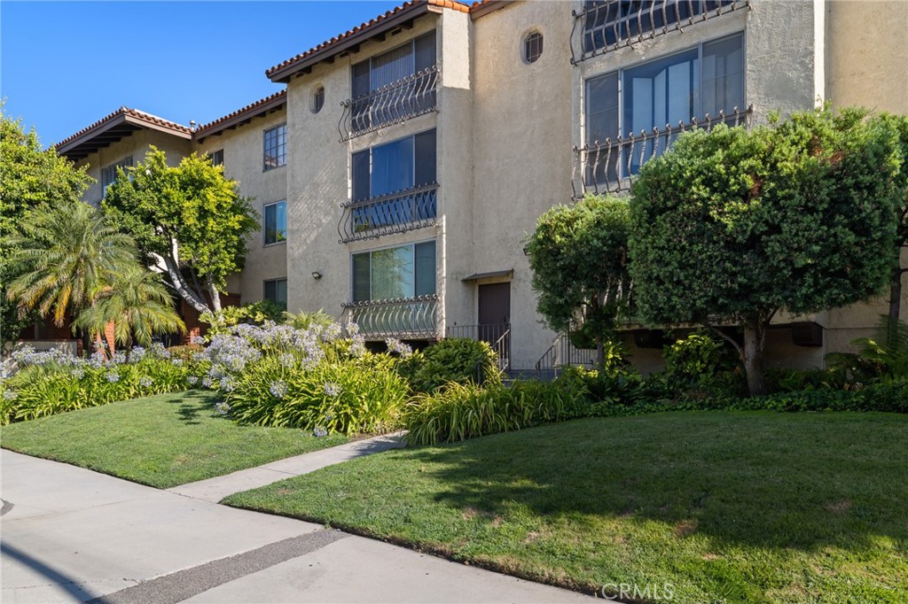 12830 Burbank Boulevard, Unit 307 Valley Village, CA 91607 - Photo 23 of 25 a view of a house with a yard and plants