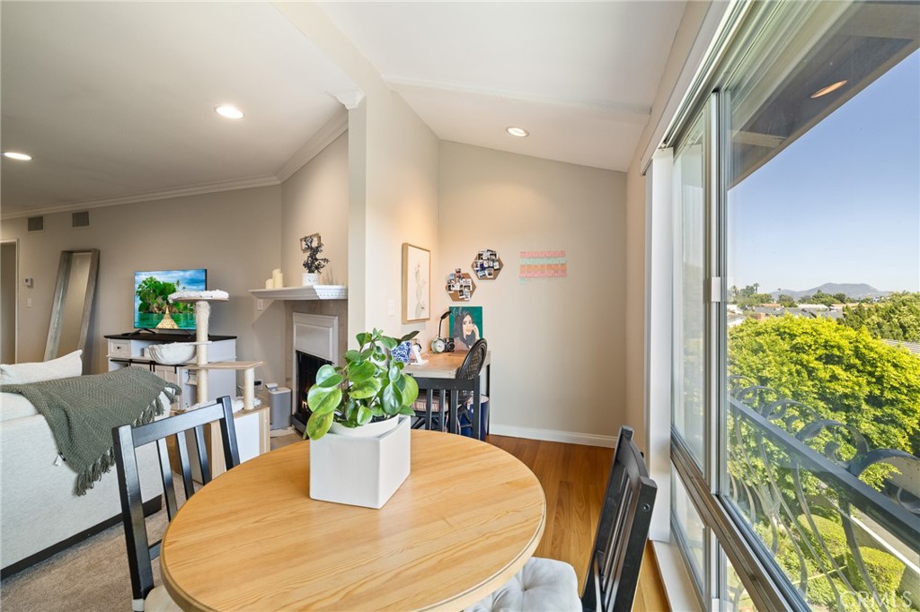 12830 Burbank Boulevard, Unit 307 Valley Village, CA 91607 - Photo 8 of 25 a dining room with furniture and wooden floor