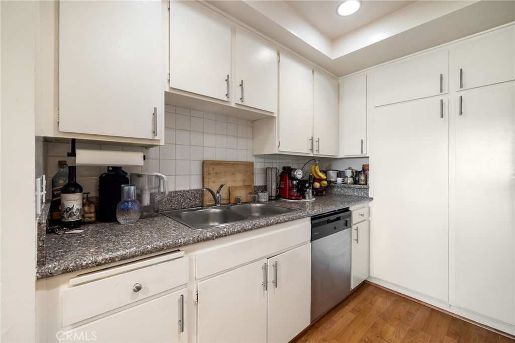 12830 Burbank Boulevard, Unit 307 Valley Village, CA 91607 - Photo 10 of 25 a kitchen with granite countertop a sink and cabinets