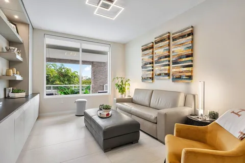 a view of a swimming pool with a patio and plants