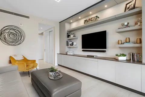 a view of a patio with table and chairs potted plants and large tree