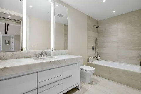 a living room with fireplace furniture and a large window