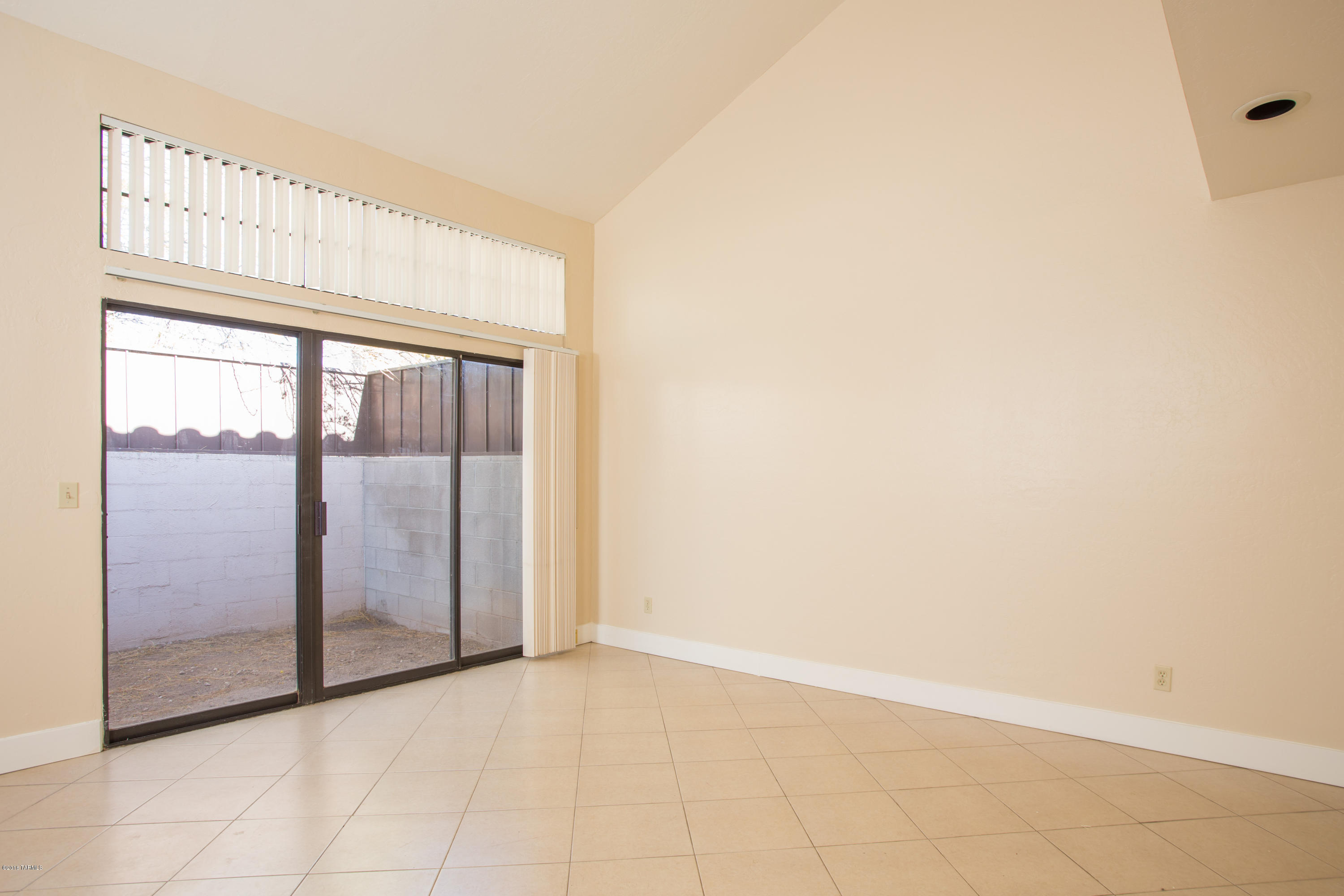 242 East Pastime Road Tucson, AZ 85705 - Photo 4 of 20 an empty room with sliding door