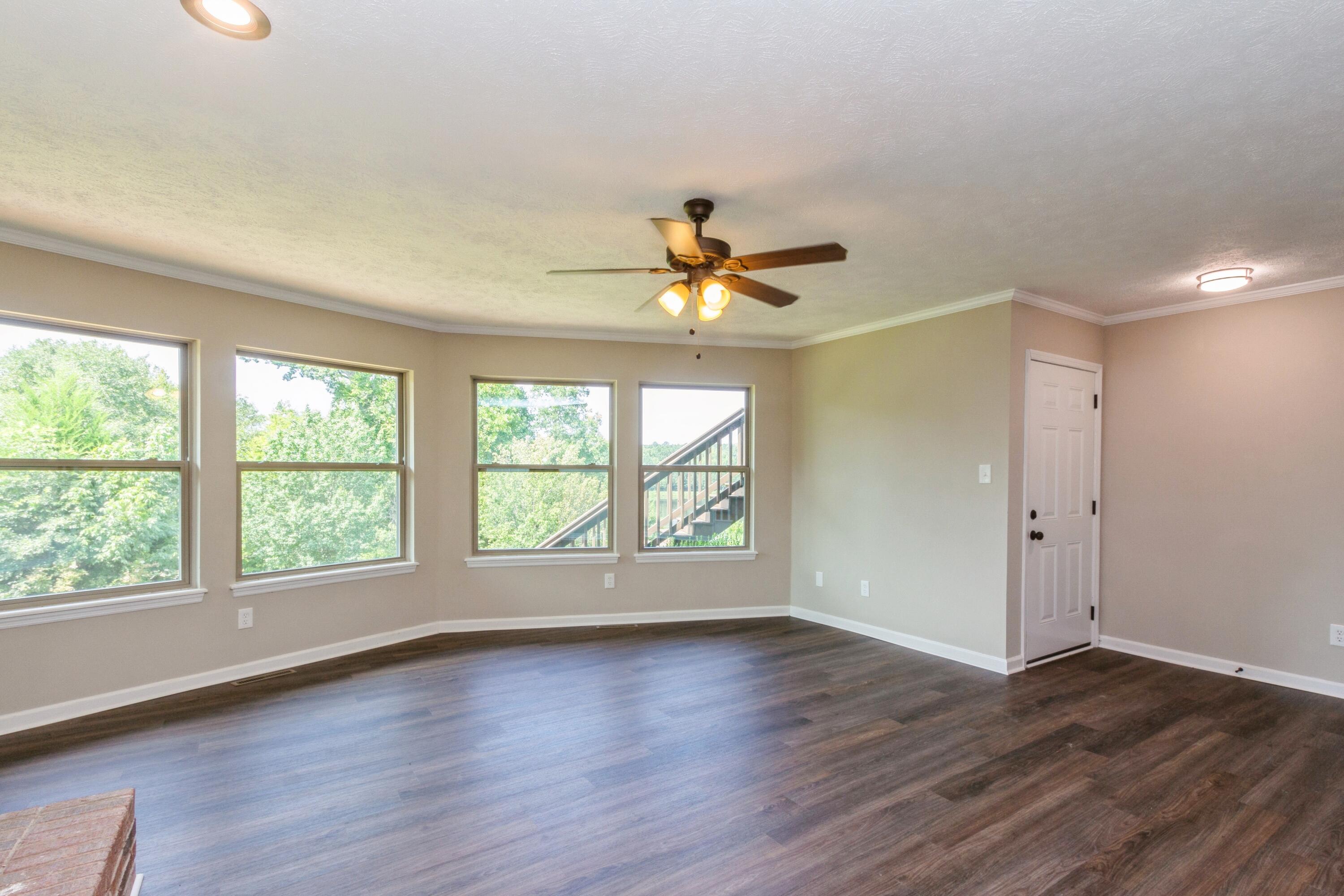 198 Hunters Run Edgefield, SC 29824 - Photo 20 of 31 a view of an empty room with wooden floor and a window