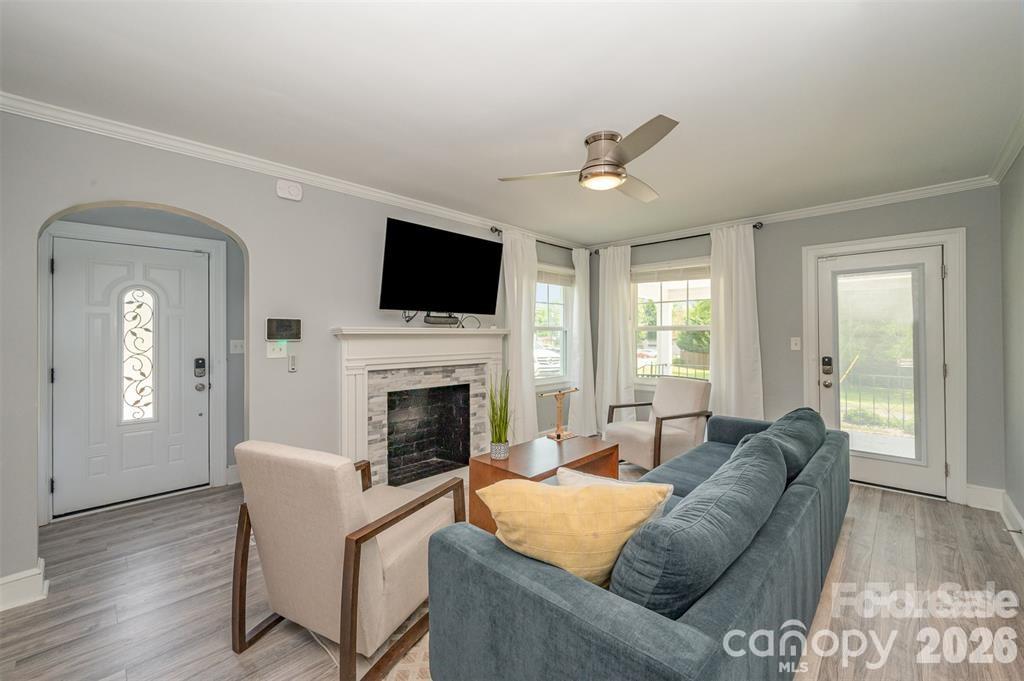 203 State Street Charlotte, NC 28208 - Photo 4 of 13 a living room with furniture a fireplace and a flat screen tv