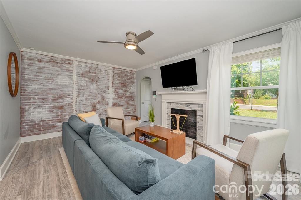 203 State Street Charlotte, NC 28208 - Photo 5 of 13 a living room with furniture a fireplace and a flat screen tv
