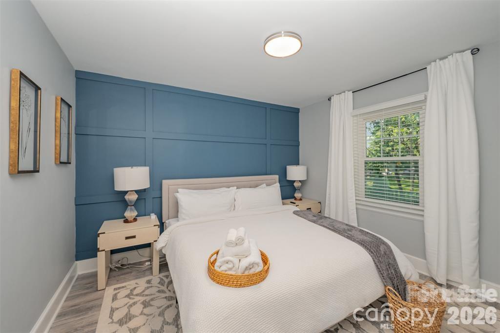 203 State Street Charlotte, NC 28208 - Photo 8 of 13 a bedroom with a bed and a chair