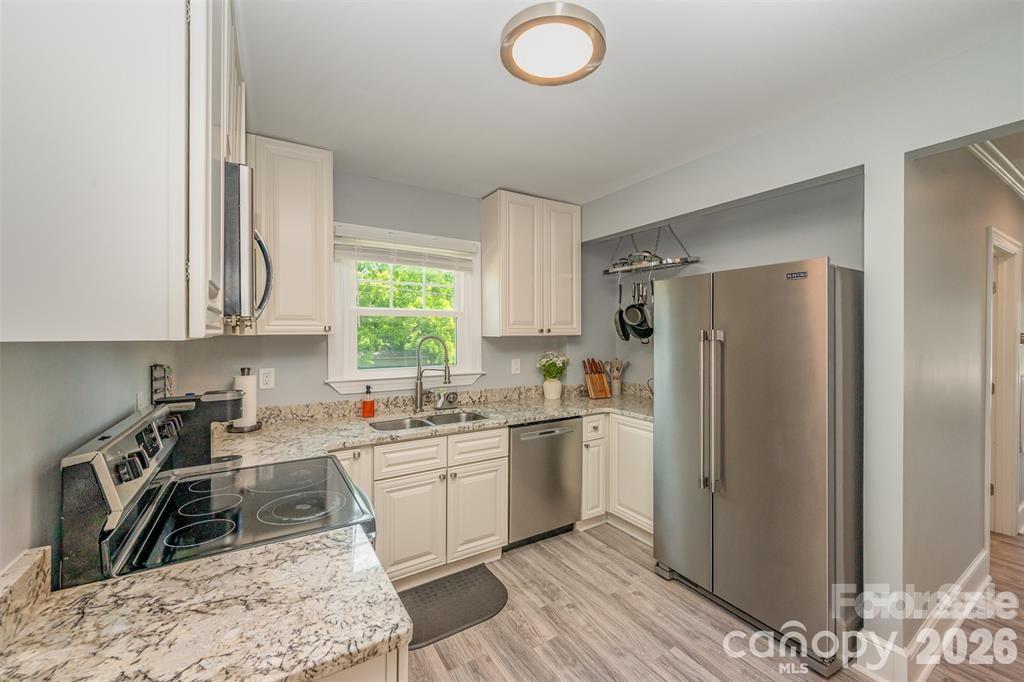 203 State Street Charlotte, NC 28208 - Photo 9 of 13 a kitchen with stainless steel appliances granite countertop a sink stove and refrigerator