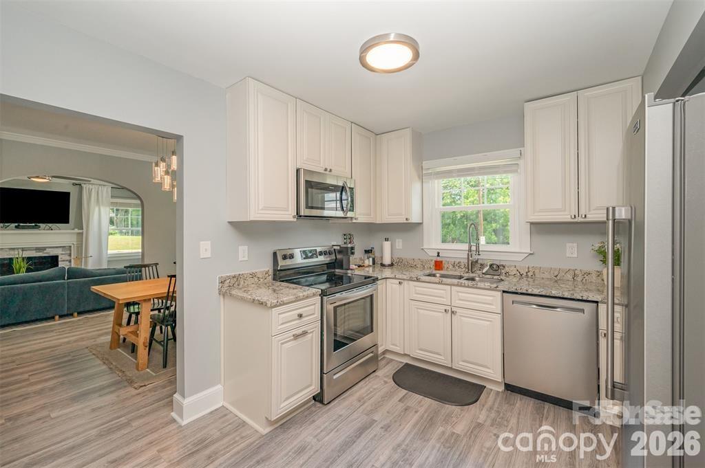 203 State Street Charlotte, NC 28208 - Photo 10 of 13 a kitchen with granite countertop cabinets stainless steel appliances a sink and a window