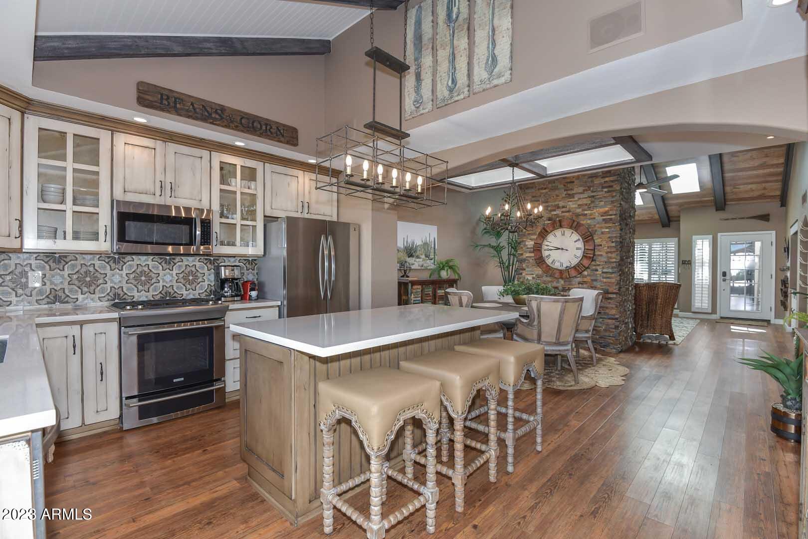 a kitchen with stainless steel appliances granite countertop a stove refrigerator and cabinets