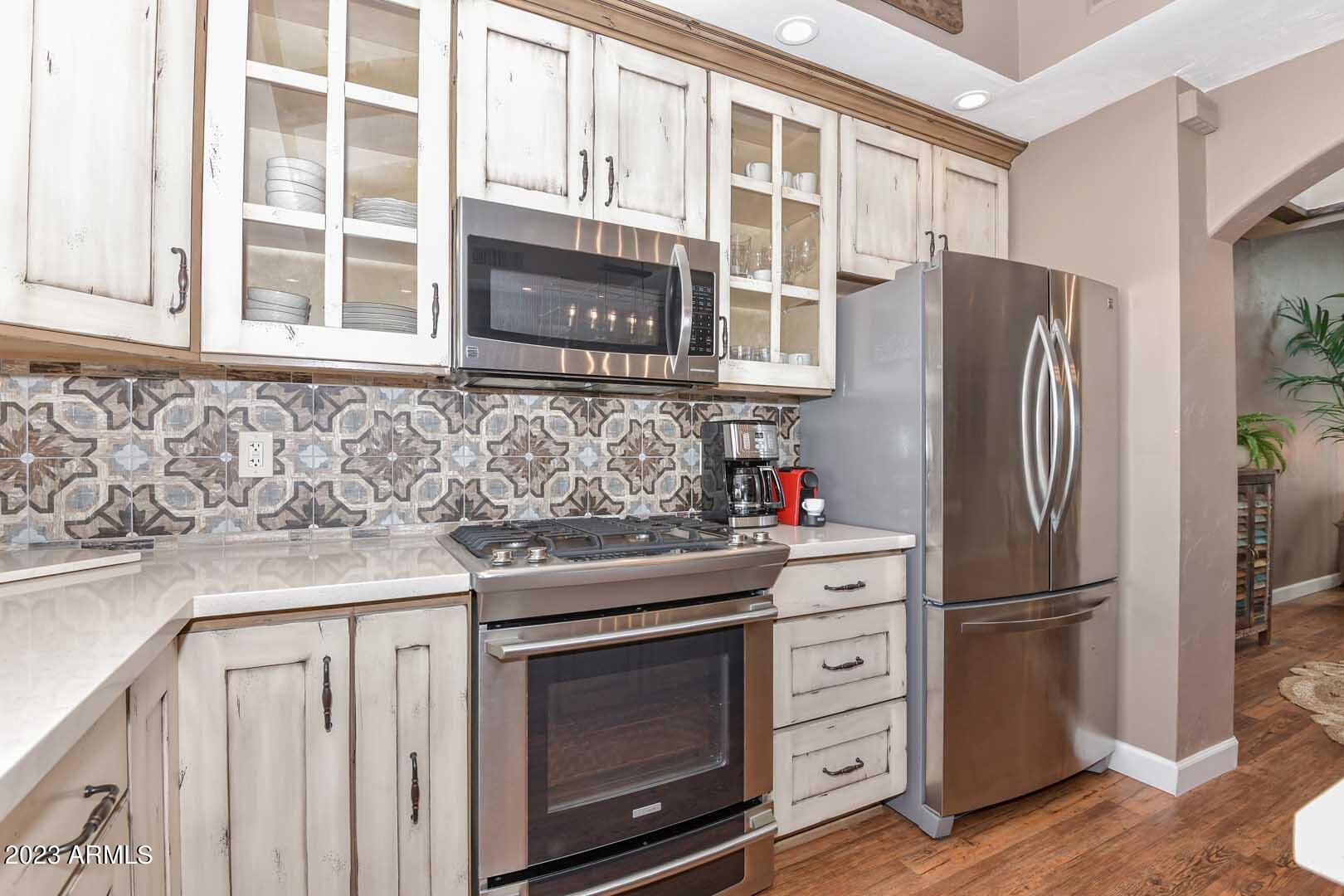 5804 North Scottsdale Road Paradise Valley, AZ 85253 - Photo 12 of 42 a kitchen with stainless steel appliances granite countertop a refrigerator and a sink