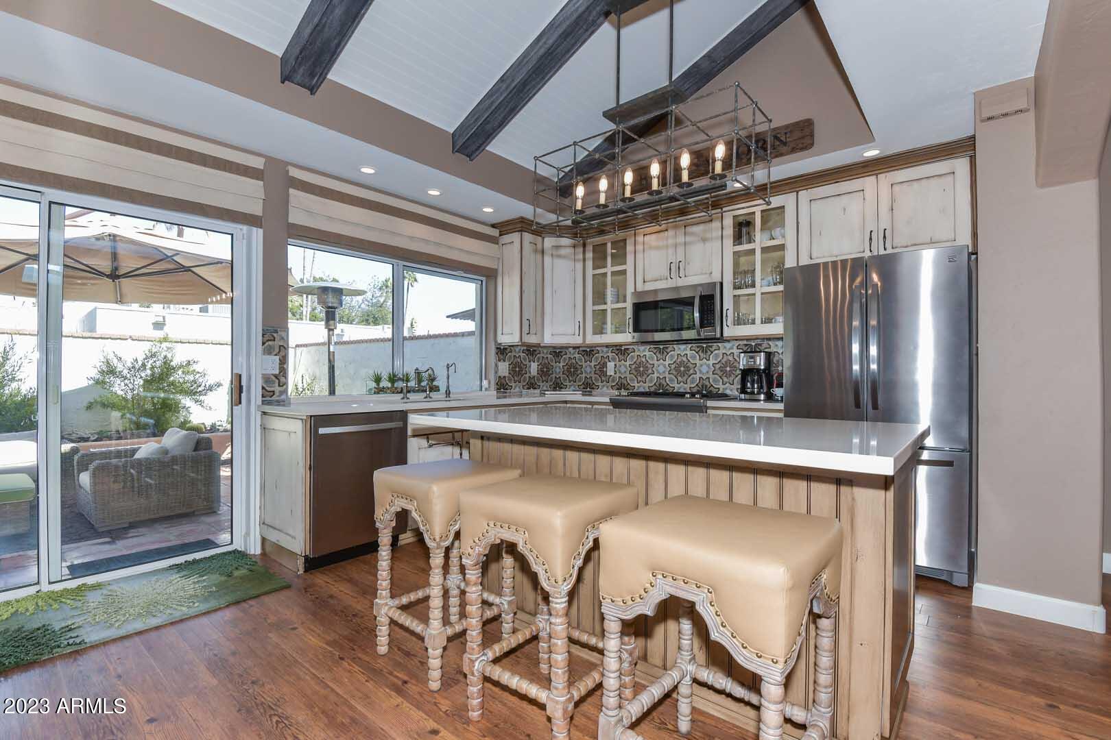 5804 North Scottsdale Road Paradise Valley, AZ 85253 - Photo 13 of 42 a kitchen with stainless steel appliances granite countertop a refrigerator a sink and a stove