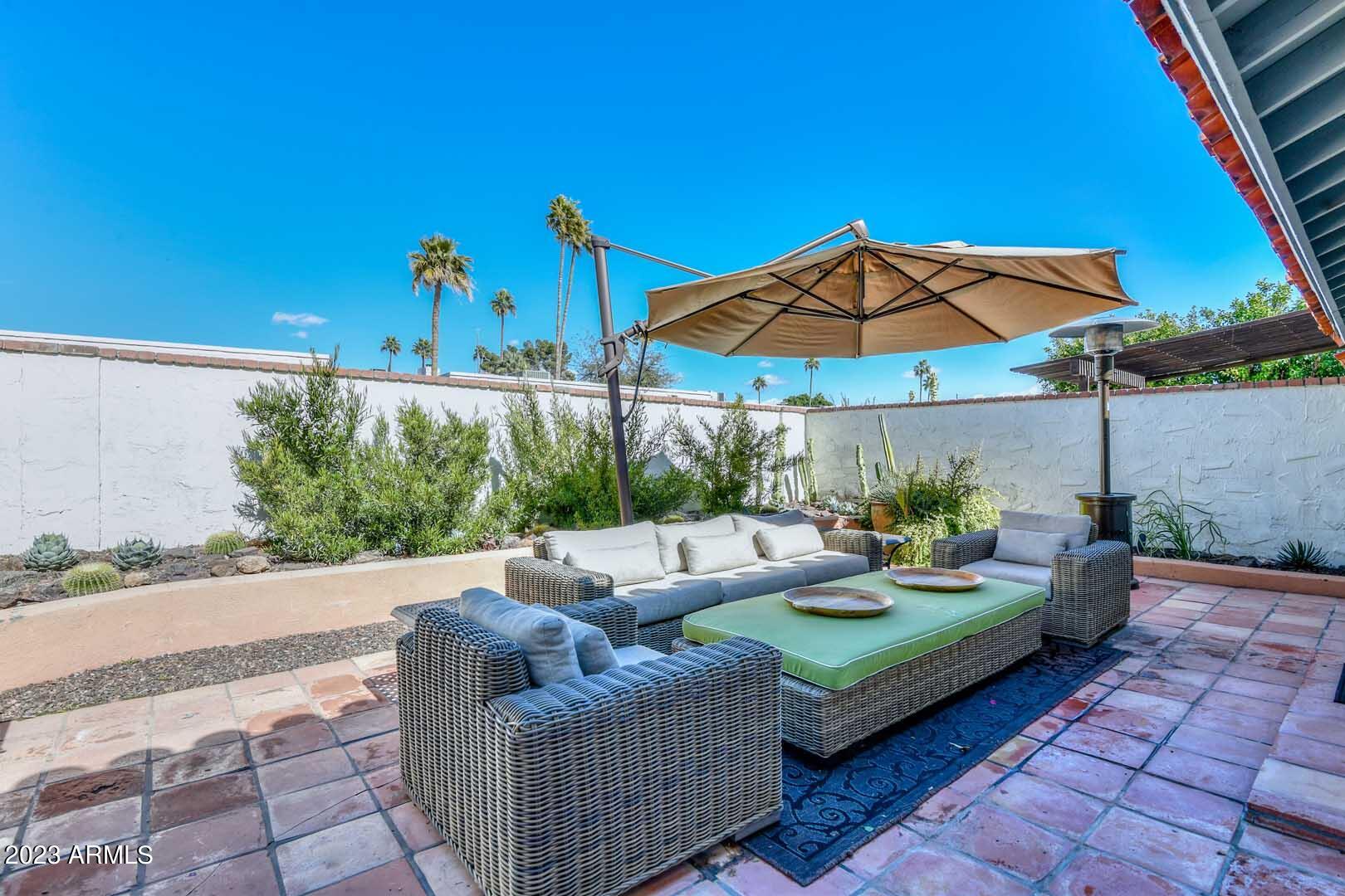 5804 North Scottsdale Road Paradise Valley, AZ 85253 - Photo 18 of 42 an outdoor sitting area with furniture and umbrella