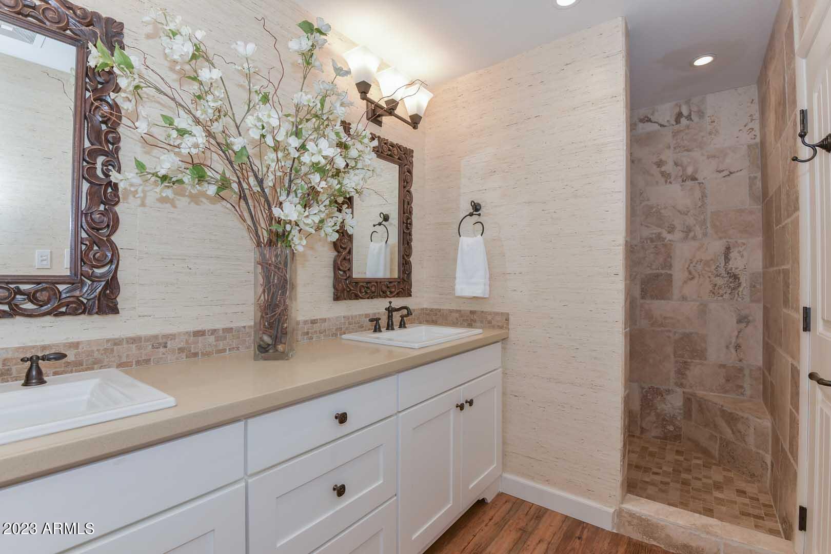 5804 North Scottsdale Road Paradise Valley, AZ 85253 - Photo 24 of 42 a bathroom with a double vanity sink mirror and shower