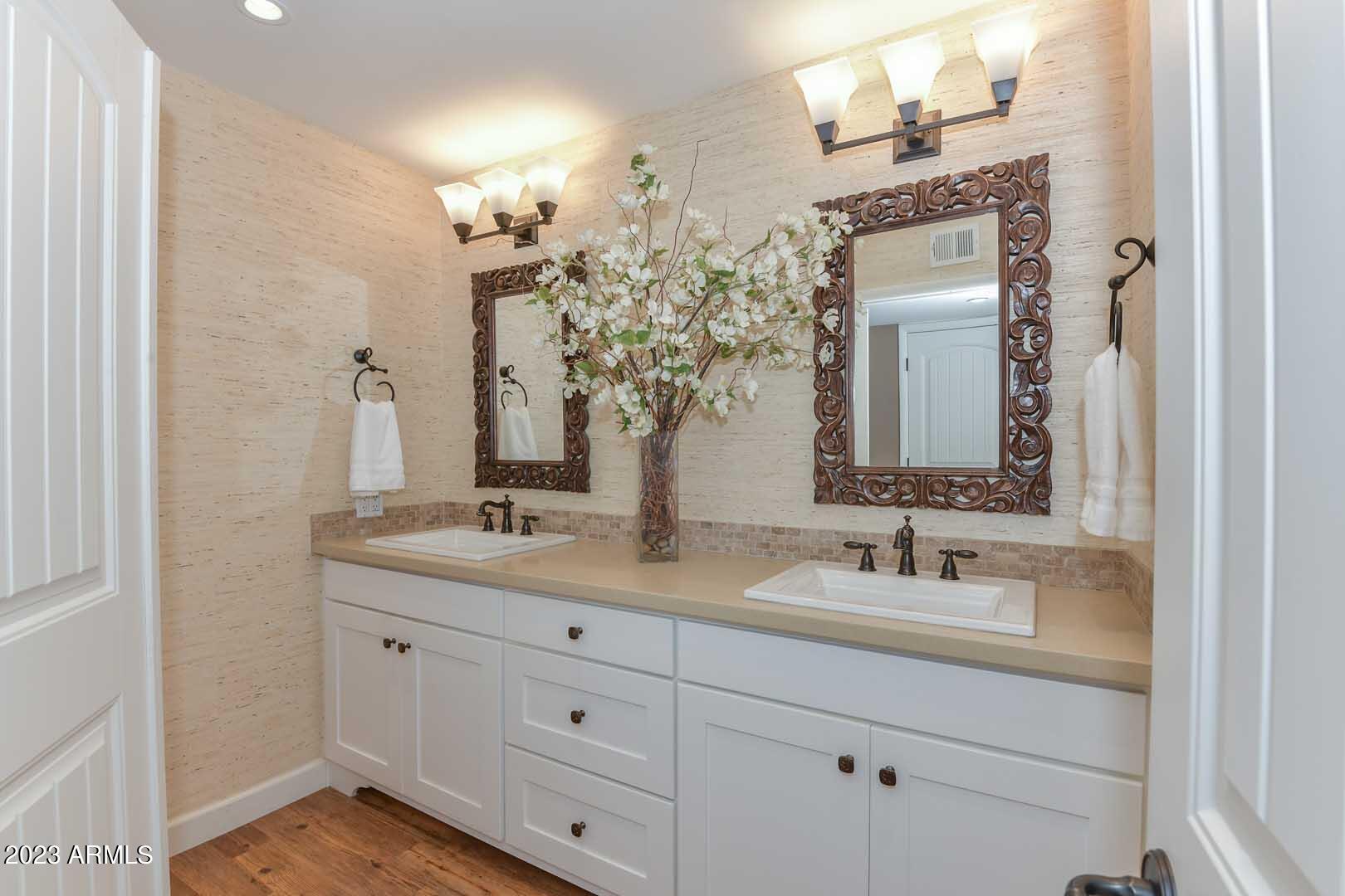 5804 North Scottsdale Road Paradise Valley, AZ 85253 - Photo 27 of 42 a bathroom with double vanity sinks and a mirror