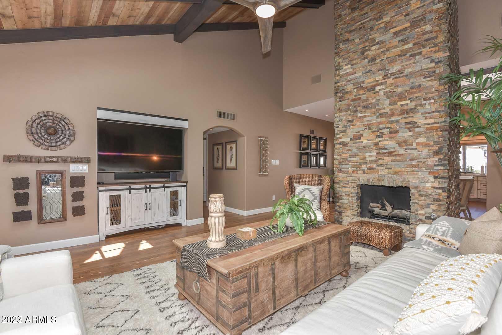 5804 North Scottsdale Road Paradise Valley, AZ 85253 - Photo 3 of 42 a living room with furniture a flat screen tv and a fireplace