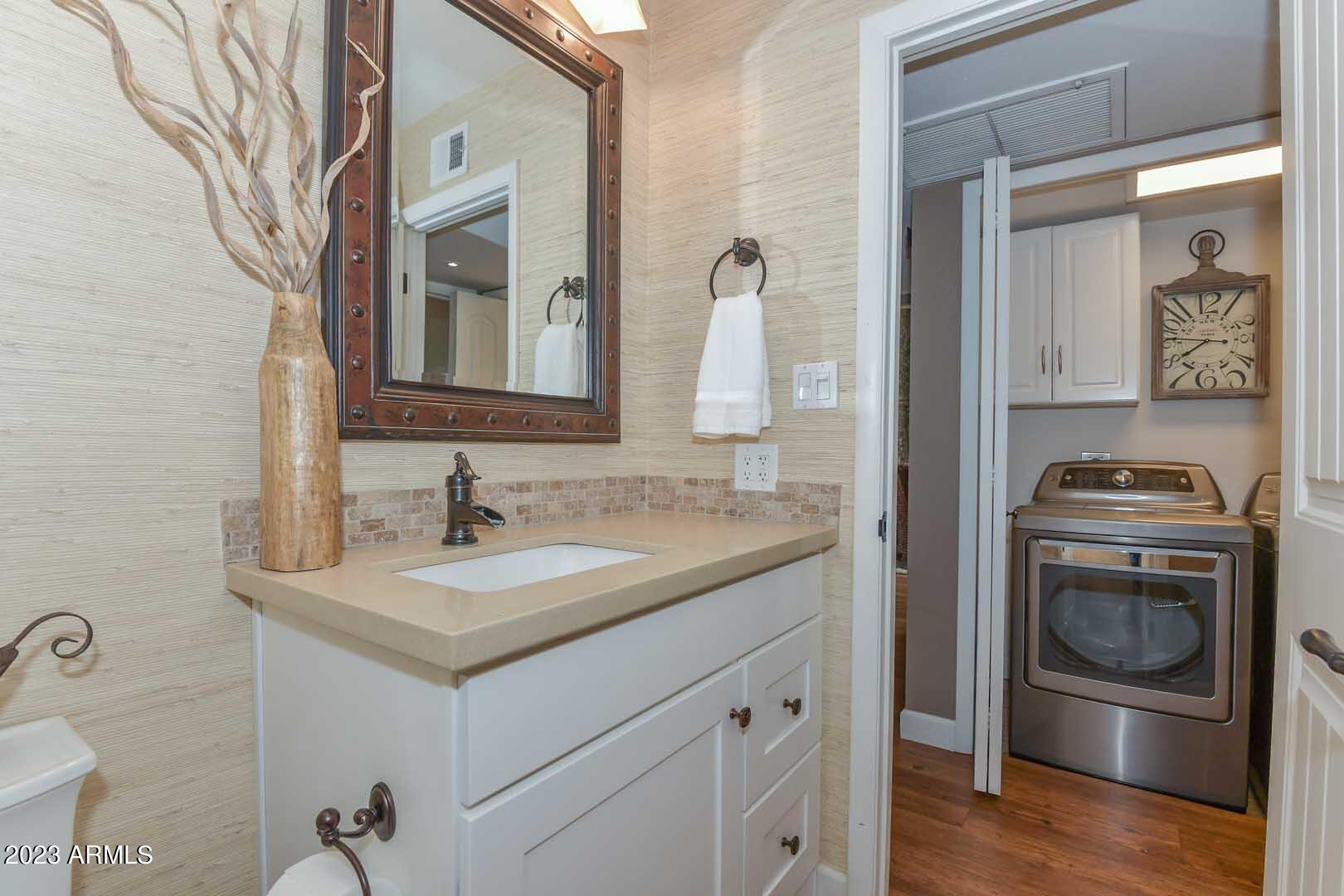 5804 North Scottsdale Road Paradise Valley, AZ 85253 - Photo 31 of 42 a bathroom with a granite countertop sink and a mirror