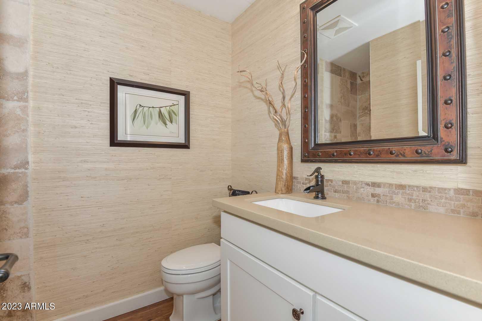 5804 North Scottsdale Road Paradise Valley, AZ 85253 - Photo 32 of 42 a bathroom with a toilet sink and mirror