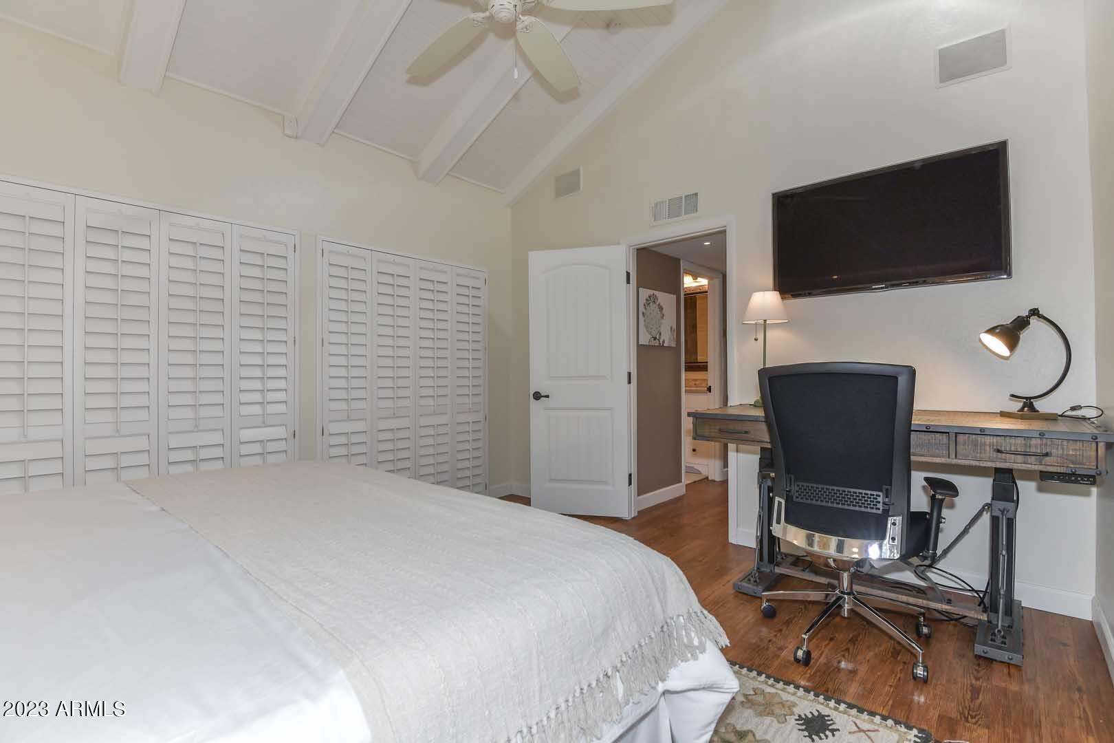 5804 North Scottsdale Road Paradise Valley, AZ 85253 - Photo 36 of 42 a bedroom with a bed tv and chair