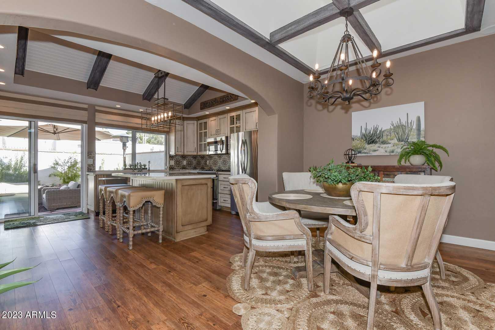 5804 North Scottsdale Road Paradise Valley, AZ 85253 - Photo 8 of 42 a dining room with furniture a chandelier and wooden floor
