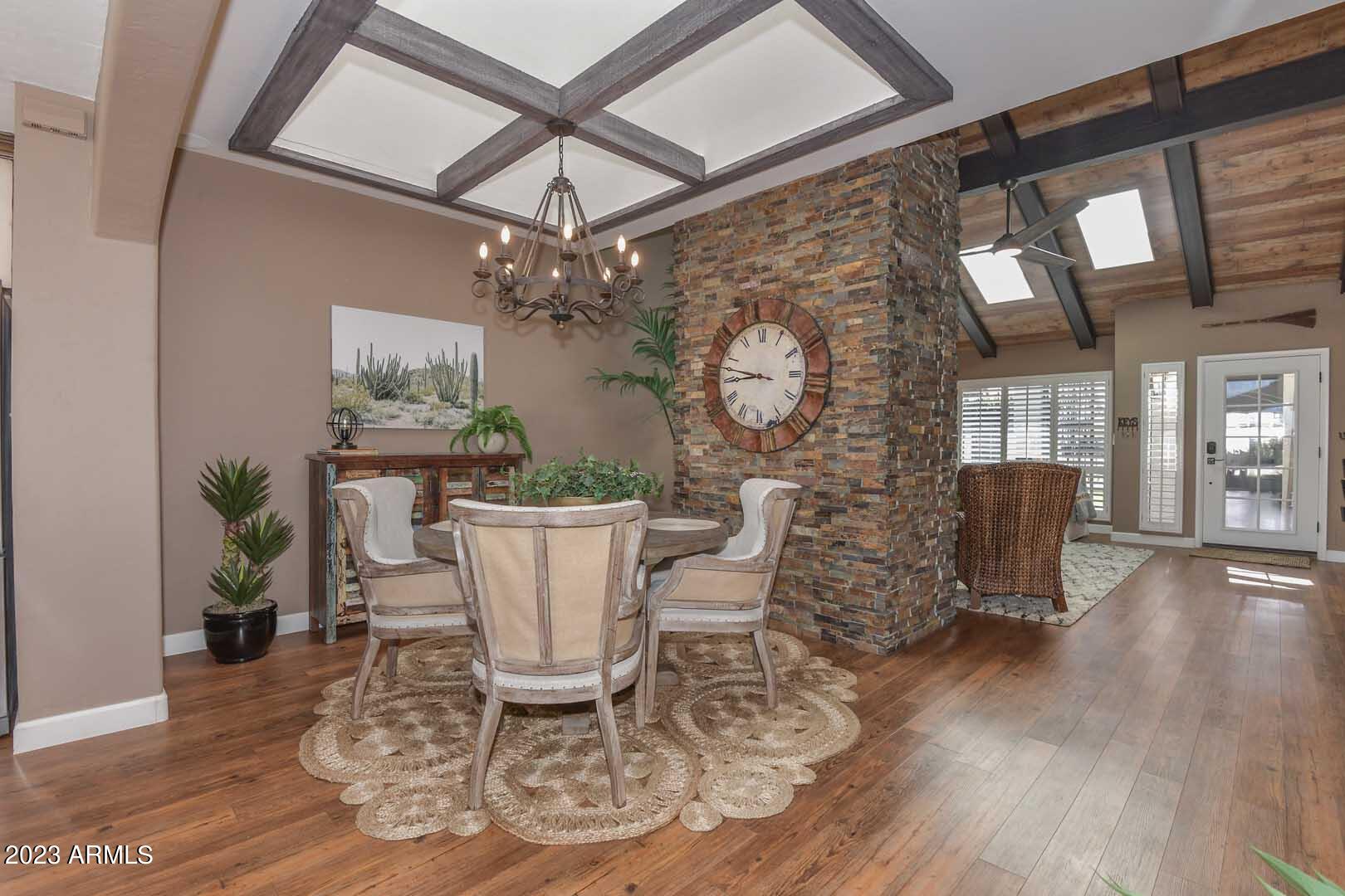 5804 North Scottsdale Road Paradise Valley, AZ 85253 - Photo 9 of 42 a view of a dining room with furniture a chandelier and wooden floor