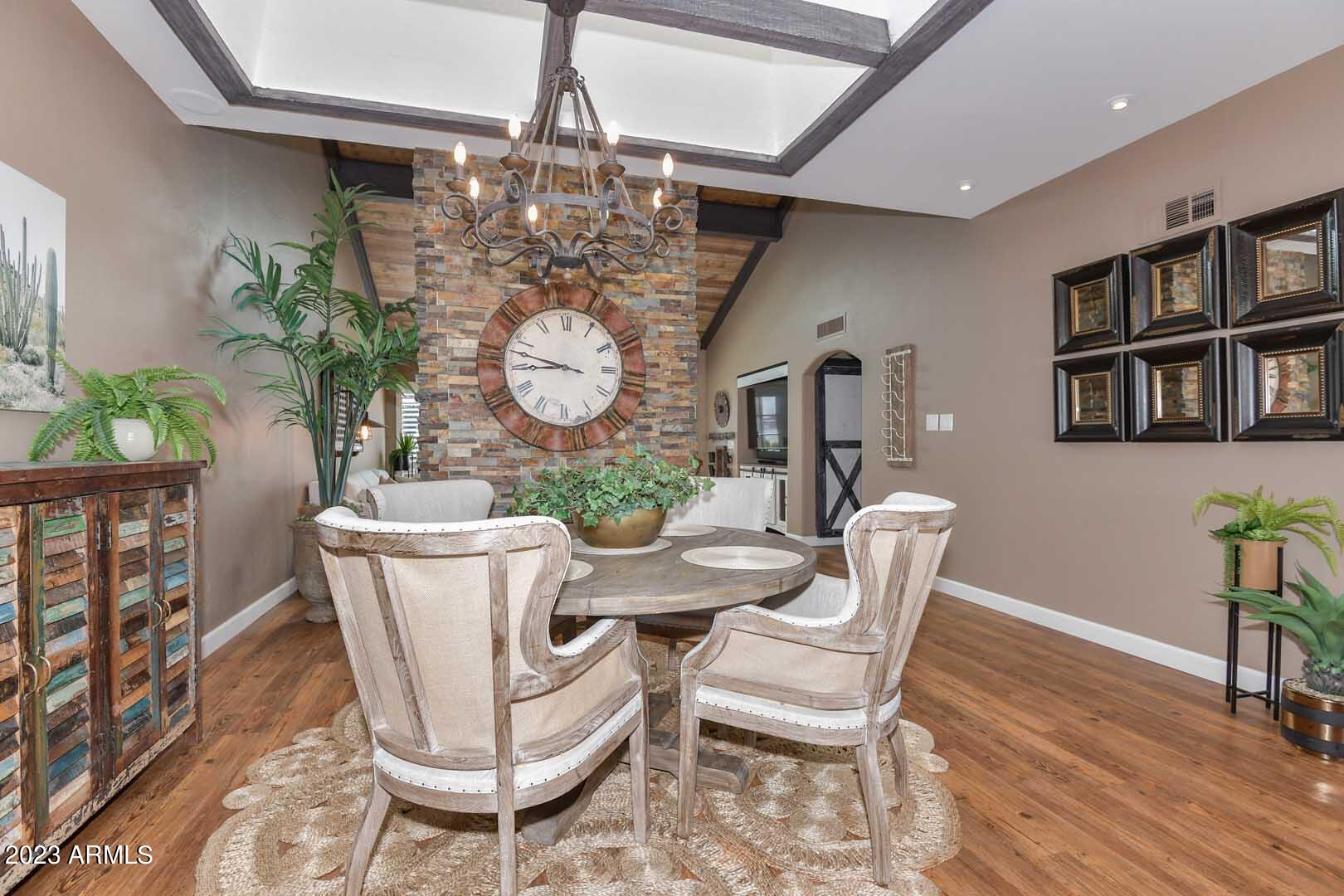 5804 North Scottsdale Road Paradise Valley, AZ 85253 - Photo 10 of 42 a dining room with furniture a chandelier and wooden floor