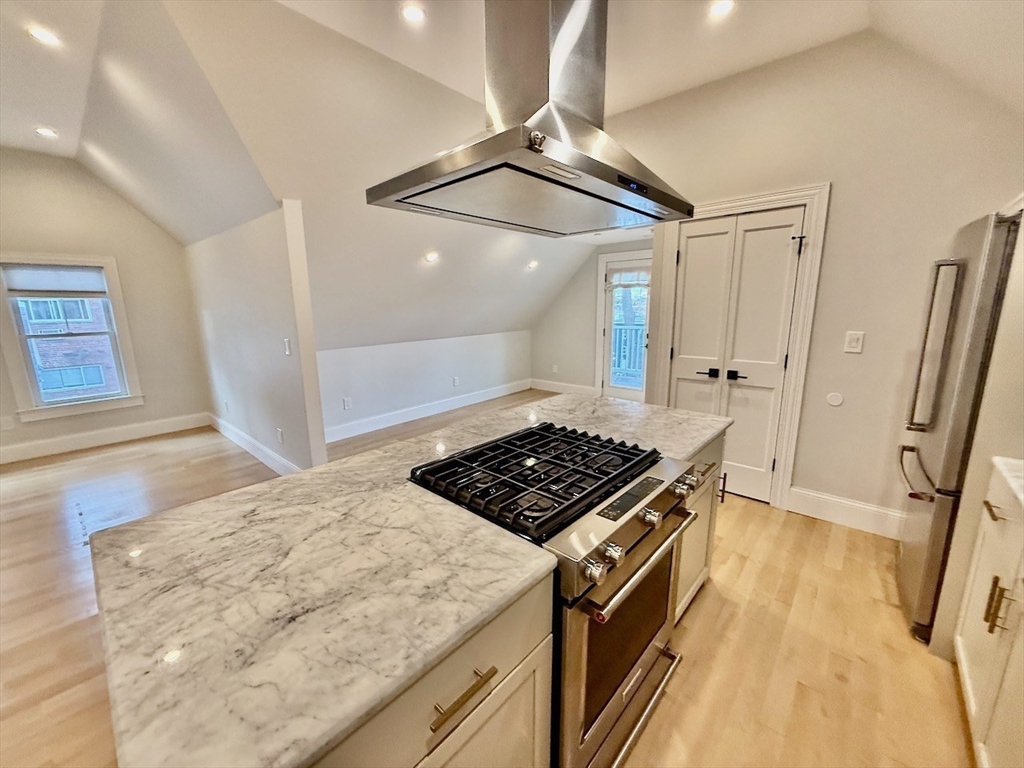 28 Dix Street, Unit 3 Boston, MA 02122 - Photo 12 of 34 a view of kitchen island wooden floor and a window