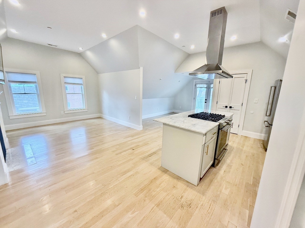 28 Dix Street, Unit 3 Boston, MA 02122 - Photo 13 of 34 a kitchen with stainless steel appliances granite countertop a sink a stove and a wooden floors