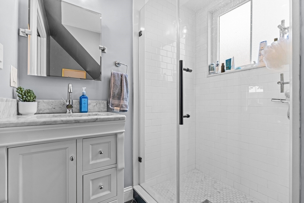 28 Dix Street, Unit 3 Boston, MA 02122 - Photo 21 of 34 a bathroom with a granite countertop sink mirror and shower